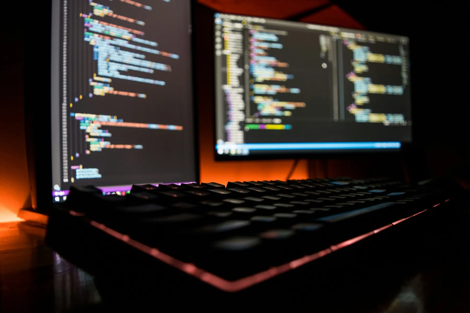 Monitors displaying code in a development environment